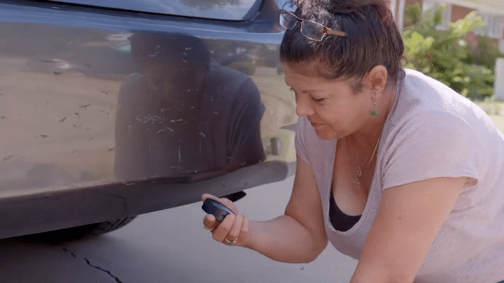 Magnetic GPS tracker being mounted under a vehicle